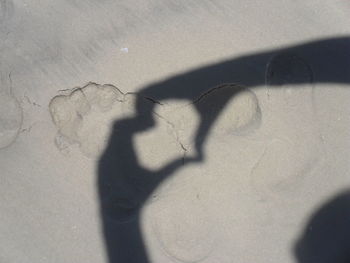 High angle view of shadow on hand