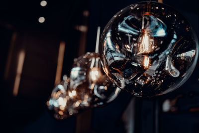 Close-up of illuminated light bulb at home