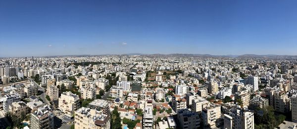 High angle view of cityscape against clear blue sky