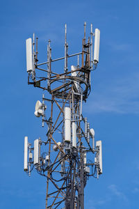 Low angle view of communications tower against sky