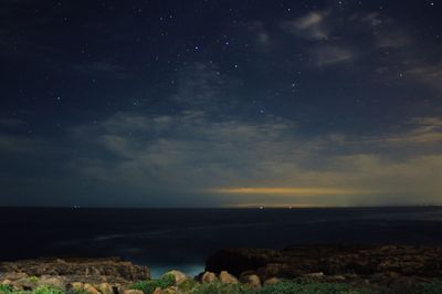 Scenic view of sea against sky at night