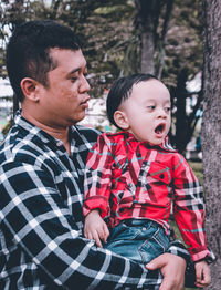 Cute boy with baby in traditional clothing