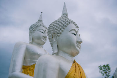Low angle view of statue against temple against sky