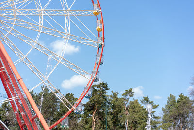 Low angle view of ferris wheel against clear blue sky