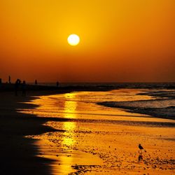 Scenic view of beach against sky during sunset