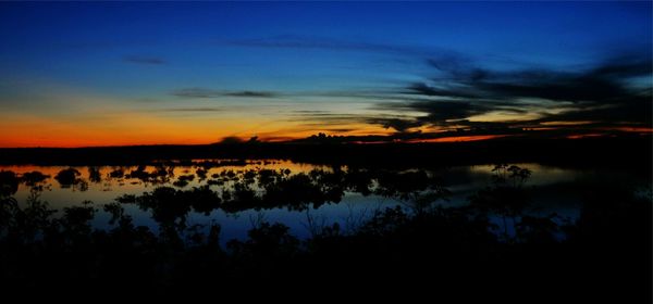 Scenic view of lake at sunset