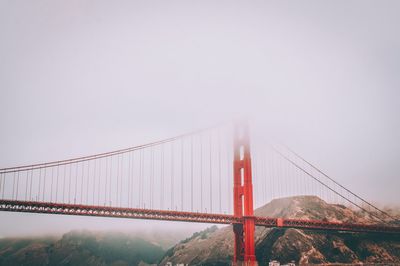 View of suspension bridge in foggy weather