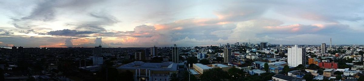 Cityscape against cloudy sky