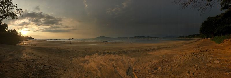 Scenic view of beach against sky during sunset