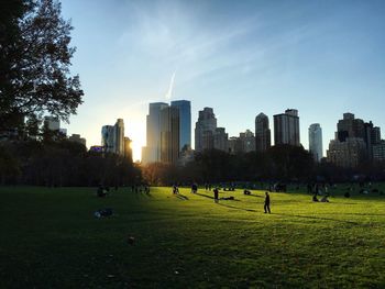 People at central park with city buildings seen in background