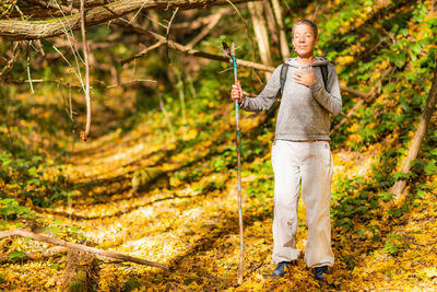Walking mindfulness. mindful middle-aged woman walking through the autumn forest.