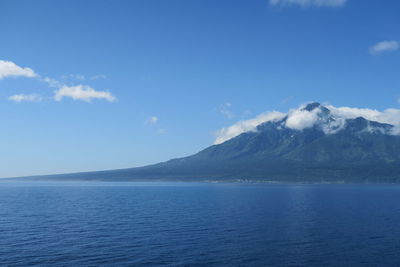 Scenic view of sea and mountains against sky