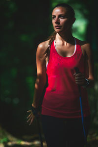 Portrait of beautiful woman standing against blurred background