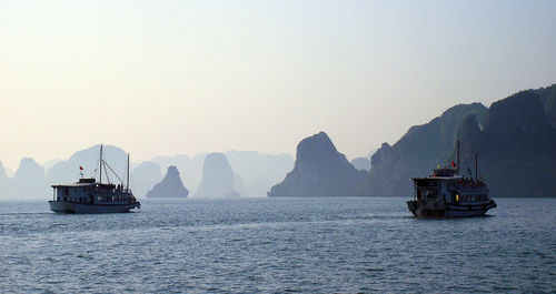 Ships on sea against clear sky