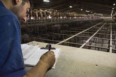 Salamanca, spain, pig farmer writing notes in a folder