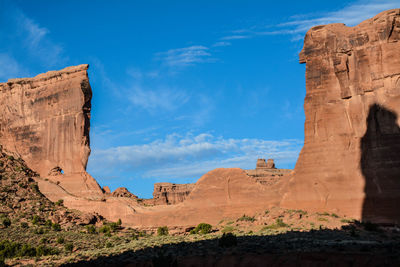 Low angle view of rock formations against blue sky