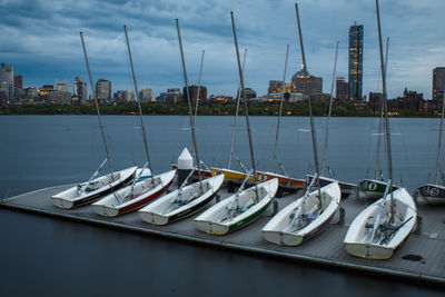 Sailboats moored in river