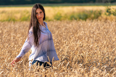 Young woman in the cornfield