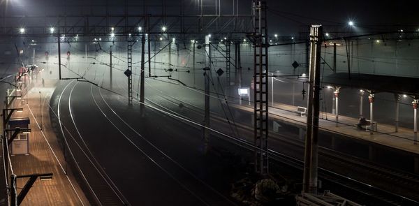 Railway tracks at railroad station at night