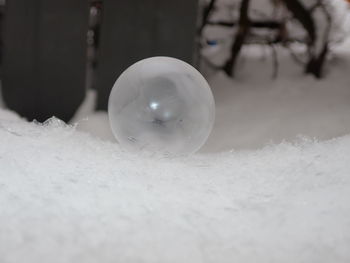 Close-up of crystal ball on snow