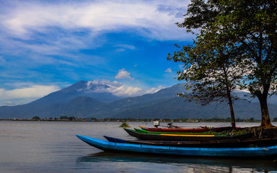 Boat moored in sea against sky