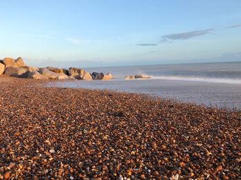 Rocks on beach against sky