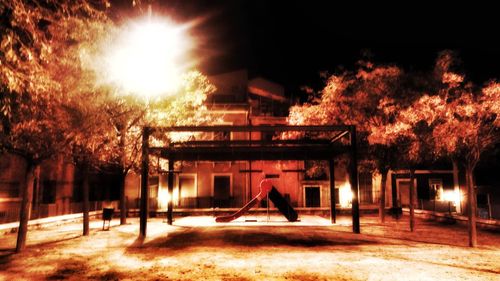Illuminated building against sky at night