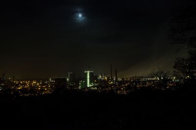 Illuminated cityscape against sky at night