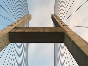 Low angle view of suspension bridge against sky