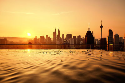 Morning scene from rooftop swimming pool to of kuala lumpur business district. 