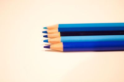 Close-up of colored pencils against white background