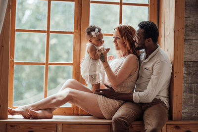 Couple sitting on window