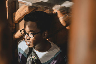 Close-up portrait of a young man looking away