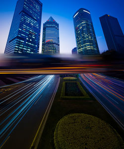 Blurred motion of illuminated modern buildings in city at night