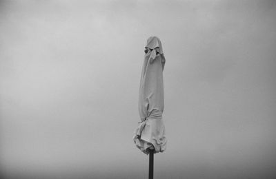 Rear view of man standing against clear sky