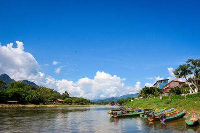 Boats in lake against sky