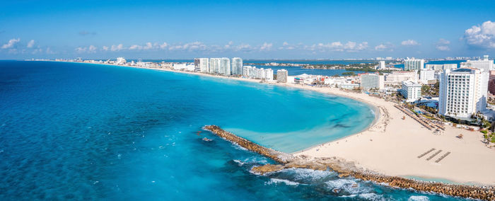 Panoramic shot of sea and buildings against sky