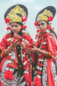 Portrait of sisters wearing traditional clothing