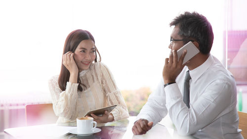 Young woman using laptop in coffee