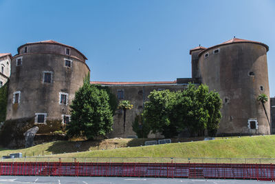 Low angle view of historic building against clear blue sky