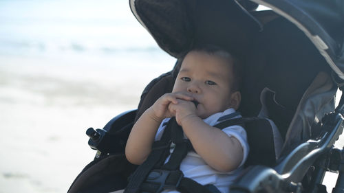 Portrait of cute baby girl in stroller