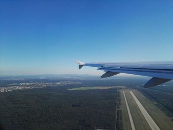 Cropped image of airplane flying over landscape