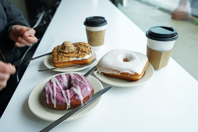 Close up assorted sweet donut served with hot coffee