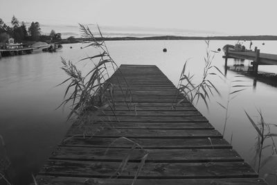 Pier over lake against sky