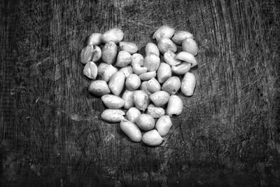 High angle view of peanuts arranged in heart shape on table