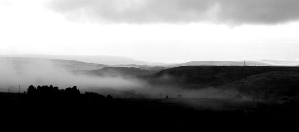 Scenic view of mountains in foggy weather