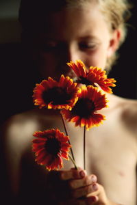 Close-up of woman holding flowers