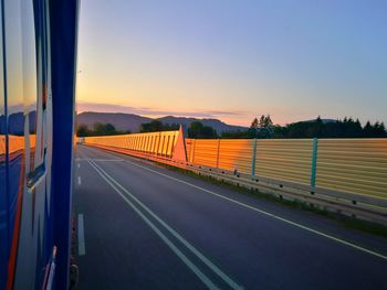 Road against clear sky during sunset