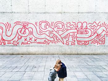 Low section of man with graffiti on street