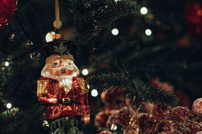 Christmas toy soldier nutcracker figurine hanging on the christmas tree. traditional festive decor,